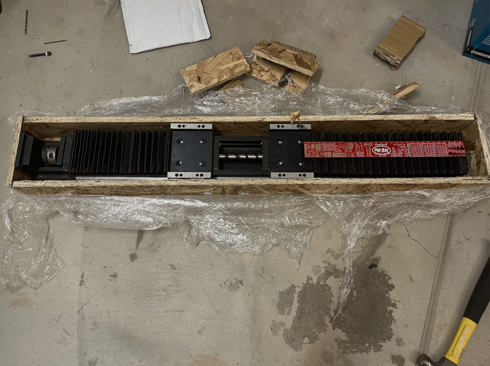 An 80mm ballscrew actuator packaged in a wooden shipping crate