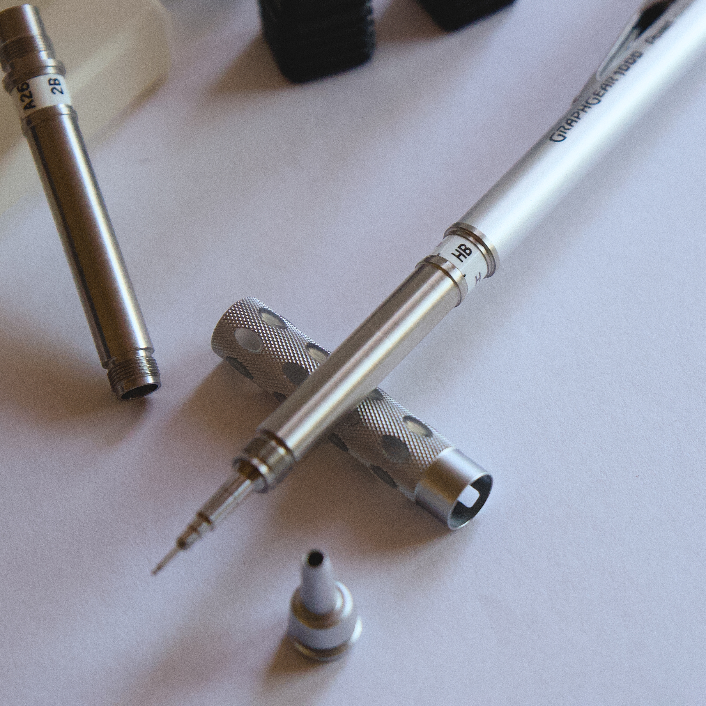 Close-up of a stainless mechanical pencil body and knurled grip