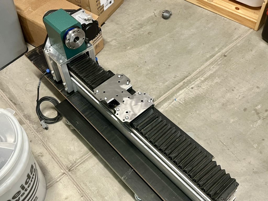 Z Axis A long aluminum frame with a black slide bolted to the top