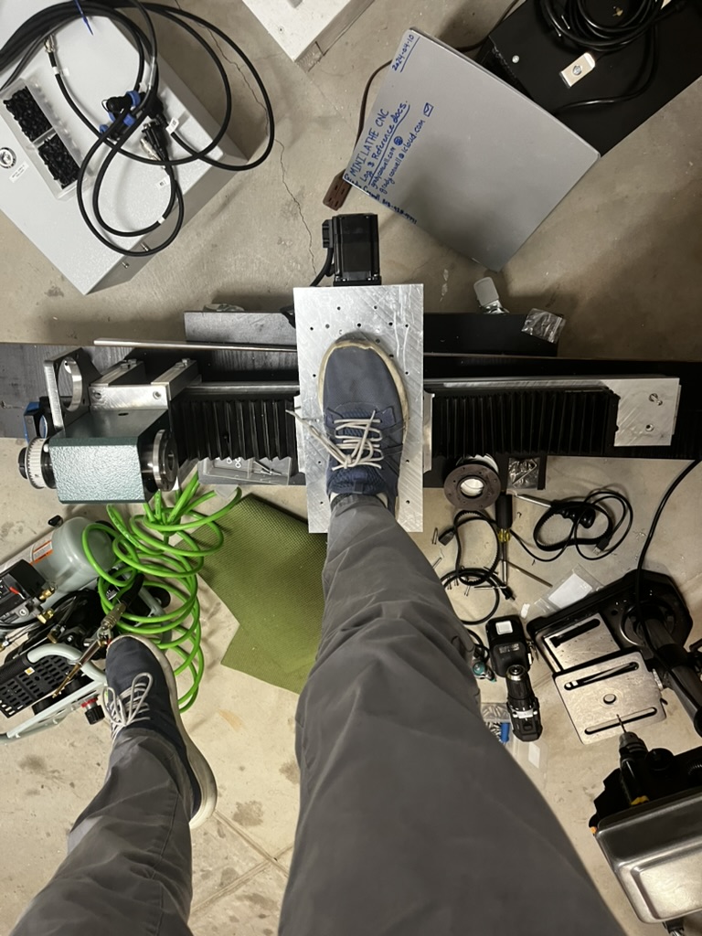 Standing on Cross Slide Picture of Grady standing on one foot atop the prototype lathe cross slide.