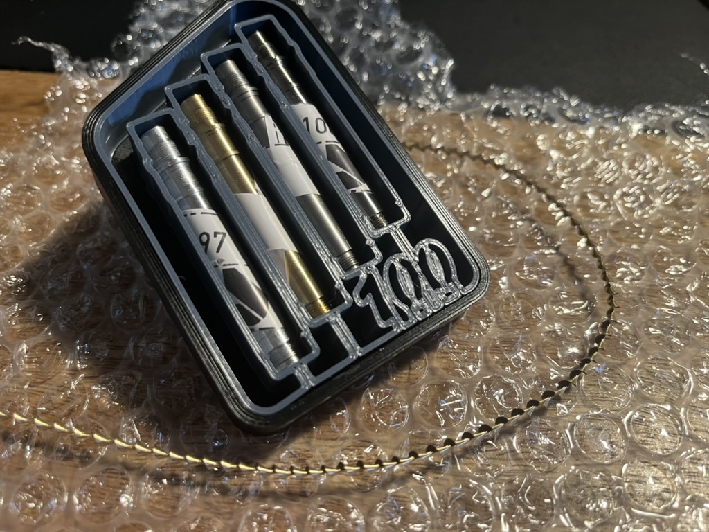 A gift box with a set of four turned pencil bodies